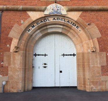 Image: large arched door sent in brick wall