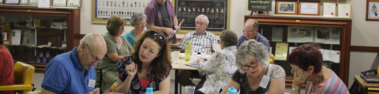 Group of people working around table.