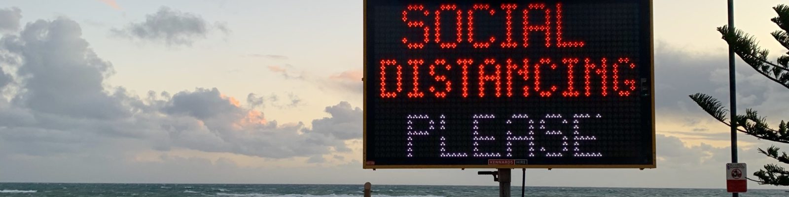 Social distancing sign at the beach