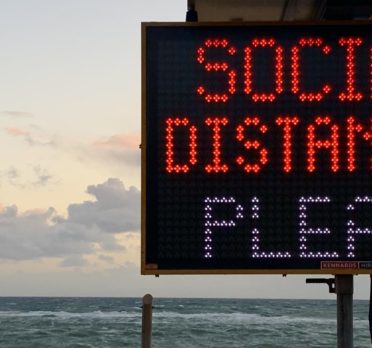 Social distancing sign at the beach
