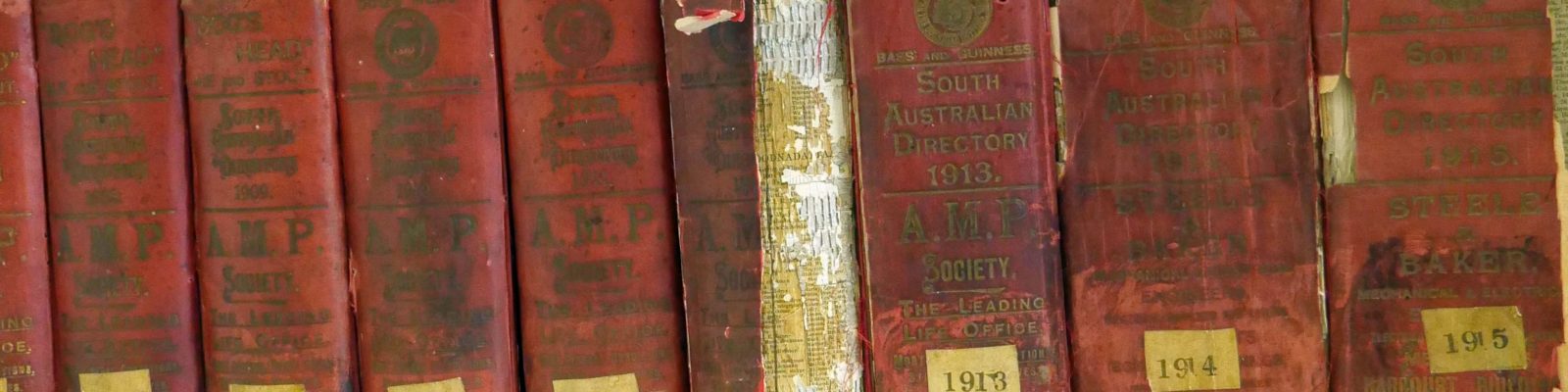 Row of books with years listed on the spines.