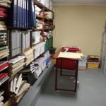 Storage area with shelves full of neatly stacked folders and other material