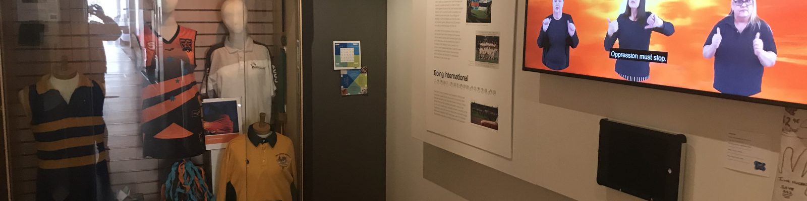 Screen showing sign language as part of gallery display.