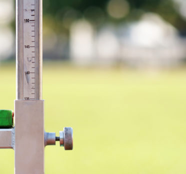 Metal pole with a ruler on it and adjustable bar.