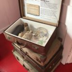 Stack of suitcases showing items salvaged from a shipwreck on display