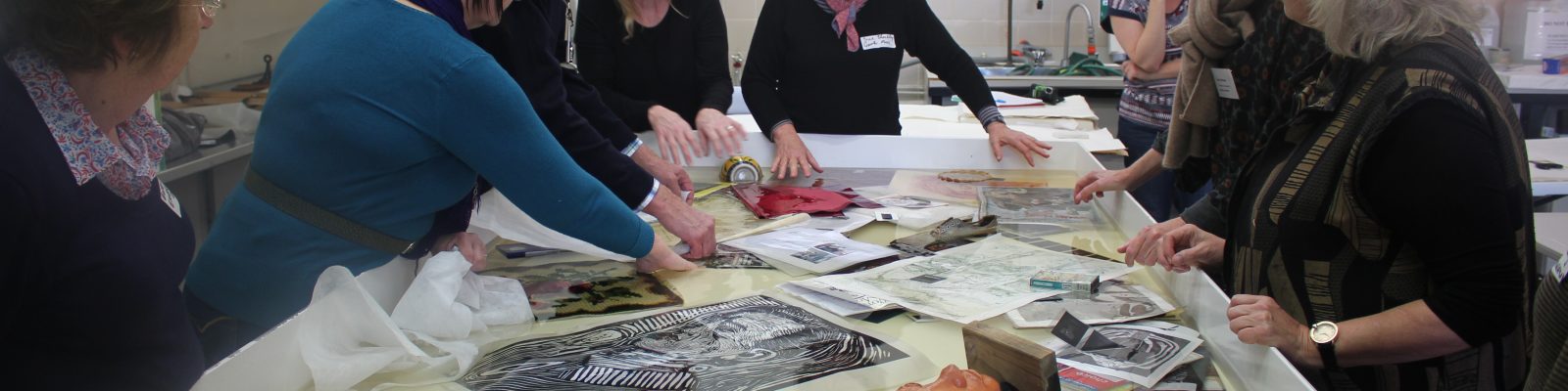 Table full of photos and other material soaked in water