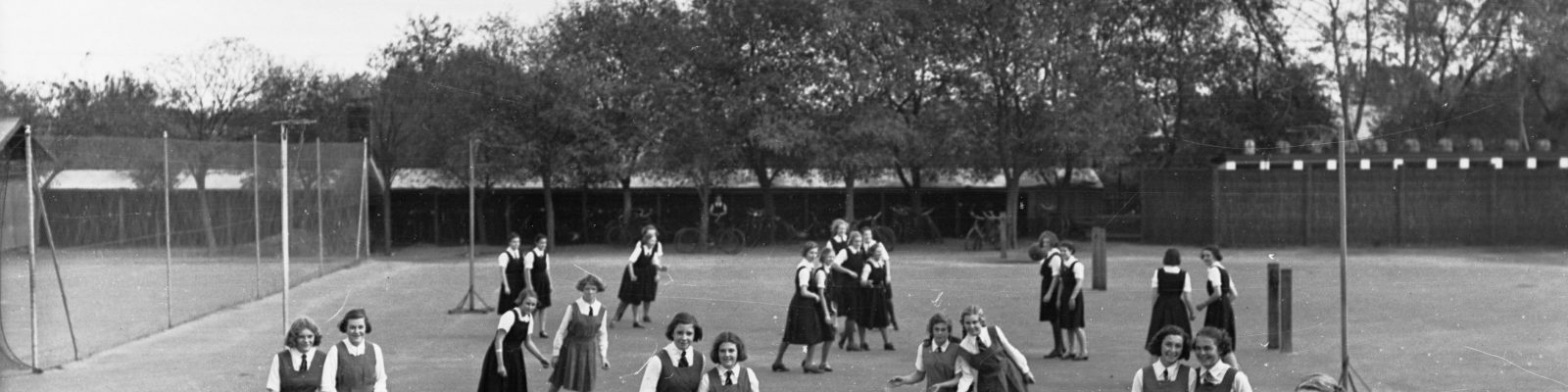 Group of girls in school uniform playing netball